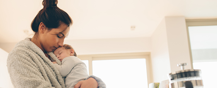 woman holding a sleeping infant