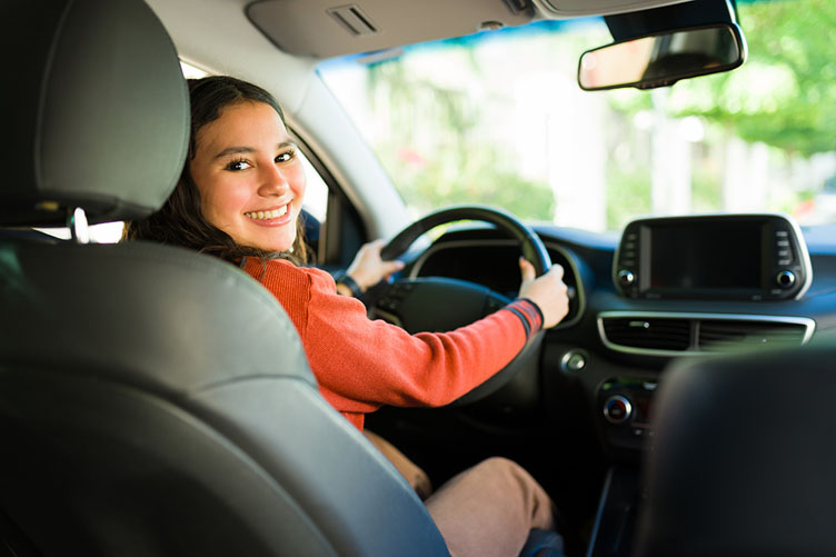 teen looking back from the driver seat
