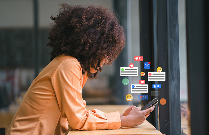 Girl leaning on desk using her cell phone