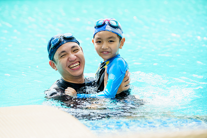 father and son in pool
