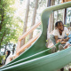 father and daugter on a playground slide
