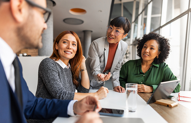 people sitting aroung a desk in an office