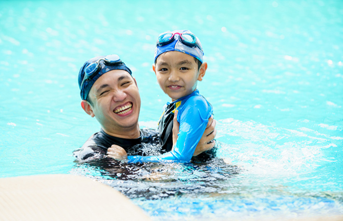 father and son in pool