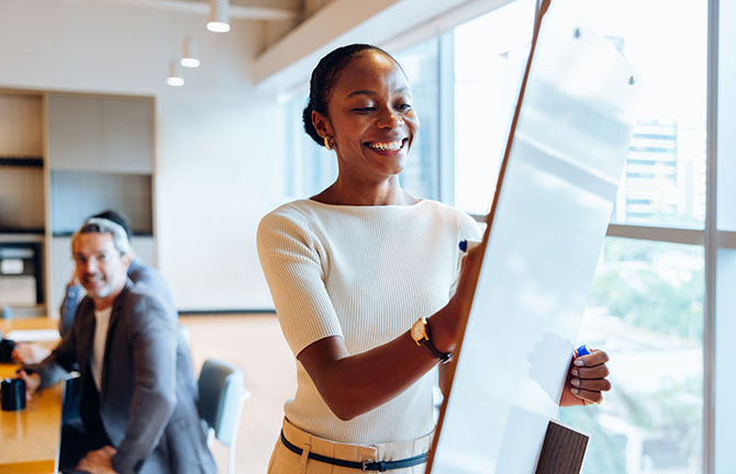 woman writing on whiteboard