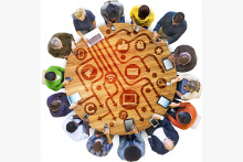 People around a round table with electronics in front of them and icons