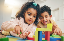 two young children playing with blocks