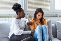 two girls sitting on the couch